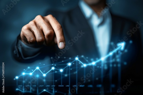 A man in a suit is pointing at a graph with a blue arrow