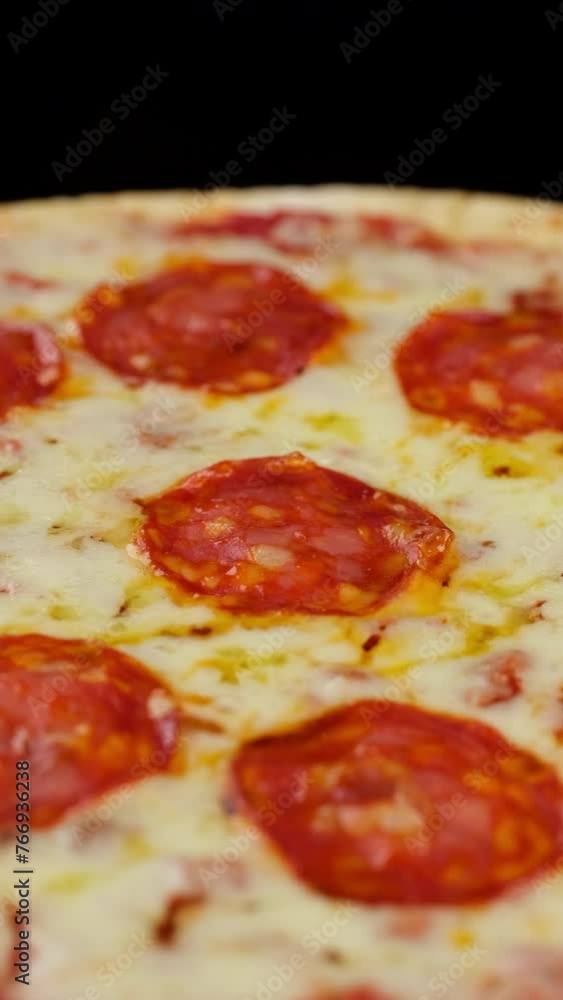 Italian pizza close up, rotation. Pepperoni pizza. Vertical video Italian pizza close up, rotation. Pepperoni pizza. Vertical video