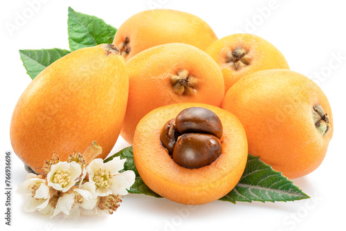 Ripe perfect loquat fruits with green leaves isolated on white background.