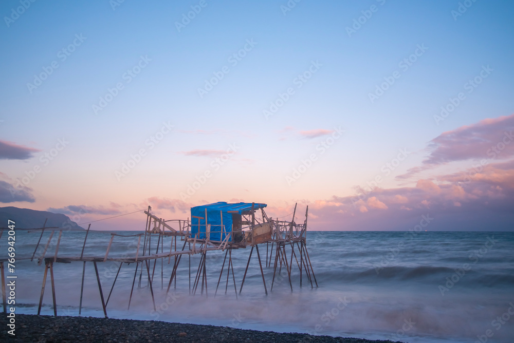 wooden fishing piers lying on the sea of Marmara cloudy weather sunset hours while the waves hit the beach wooden fishing piers lying on the sea of Marmara cloudy weather sunset hours while the waves hit the beach