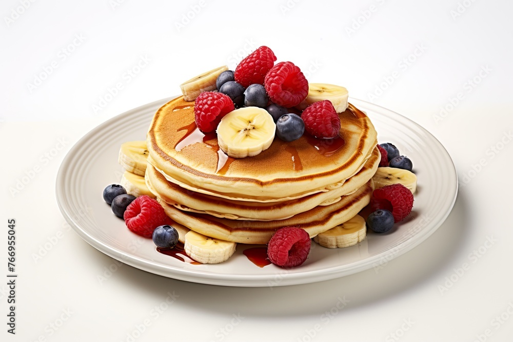 American pancakes with raspberries, blueberries, bananas and syrup on top American pancakes with raspberries, blueberries, bananas and syrup on top