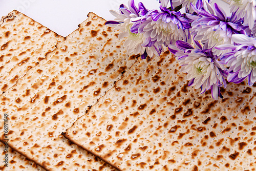 Passover background with matzah and white and purple gerberas. Jewish holiday. View from above. Passover Passover Seder Passover celebration concept. Passover.