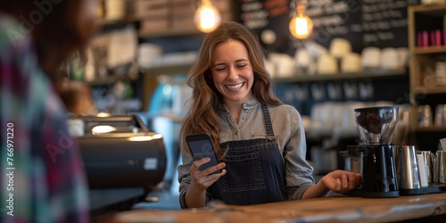 Smiling barista and a female customer paying with a phone at nfc , © Muhammad