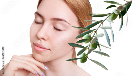 Beautiful young woman near green natural olive leaves.