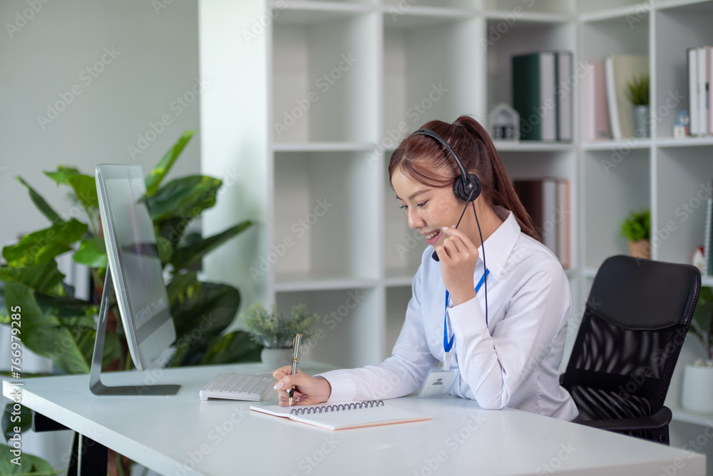 Portrait of happy smiling female customer support phone operator at workplace. Asian Portrait of happy smiling female customer support phone operator at workplace. Asian