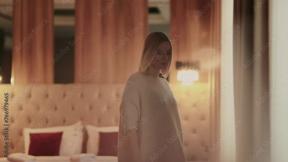 A beautiful blonde in a hotel room. Artistic paintings of women indoors. A beautiful blonde in a hotel room. Artistic paintings of women indoors.