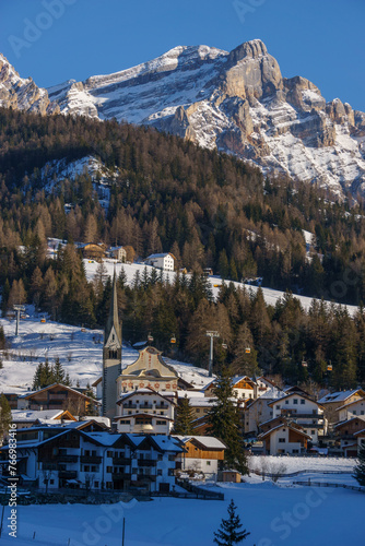 Idyllic dolomite village during winter with snow covered mountains in Alta Badia at nature park Fanes-Sennes-Prags, Abtei, Badia, South Tirol, Italy