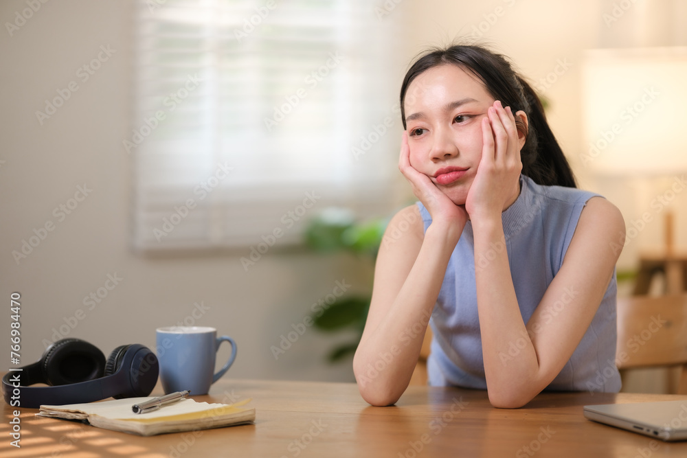 Asian college students are stressed out Sitting in front of a laptop studying online through a video calling program on a laptop at home. Asian college students are stressed out Sitting in front of a laptop studying online through a video calling program on a laptop at home.