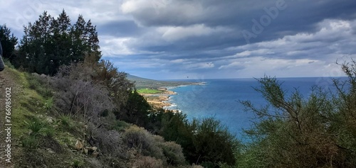Beautiful blue Mediterranean sea from mountain trail, storm approaching.
