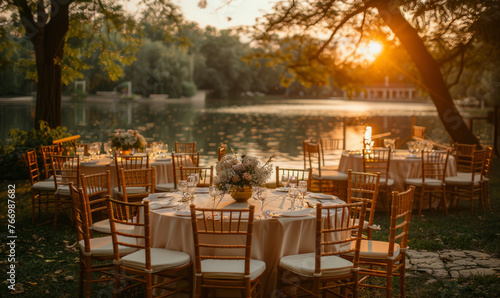 Very beautiful and creatively designed wedding dinner tables and chairs outdoor in a beautiful green park with wedding flowers