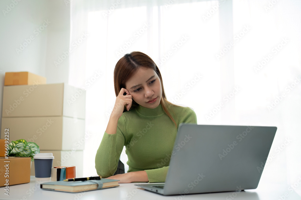 Small Business, Startup SME, Owner Entrepreneurs. Asian woman with unsuccess business online shopping crying and serious face unhappy mood.