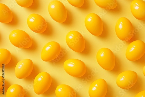 Pattern of yellow eggs on bright yellow background creating a vibrant and cheerful composition