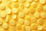 Vibrant Yellow Candies Spread on Yellow Background with Copy Space, Sweet Treats Concept for Advertising or Promotion