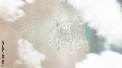 Earth zoom in from space to Al Ahmadi, Kuwait. Followed by zoom out through clouds and atmosphere into space. Satellite view. Travel intro. Images from NASA photo