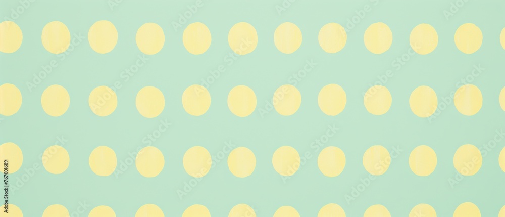 Pattern of pastel yellow circles on a soft mint green backdrop