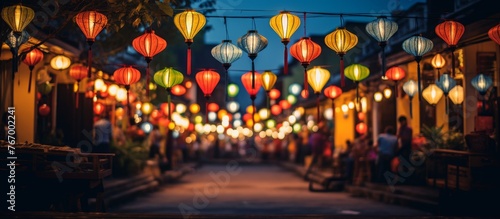 A city street adorned with vibrant lanterns illuminating the facade of buildings, creating a colorful display of art and design in the midnight hours