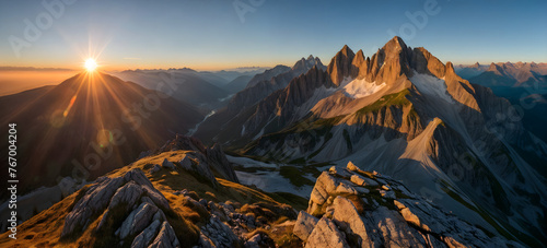 The sun crests the horizon, bathing the steep, rocky mountain peaks in a warm golden light during early morning