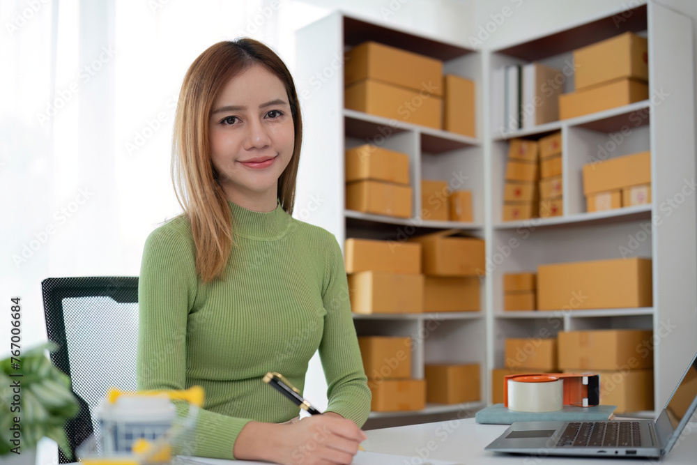 Portrait of Starting small businesses SME owners female entrepreneurs working on receipt box and check online orders to prepare to pack the boxes, sell to customers, SME business ideas online.