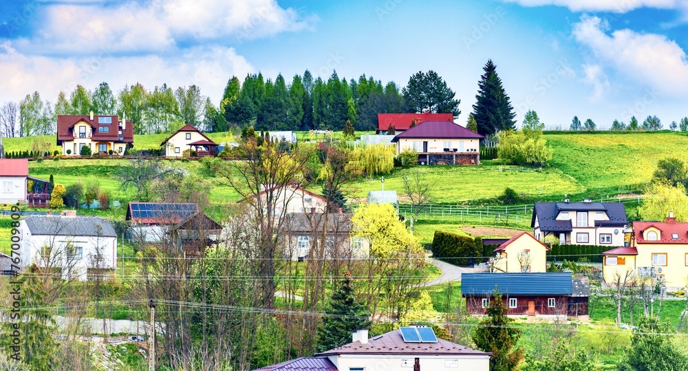 A village on the bank of a small river. Spring landscape. Poland.