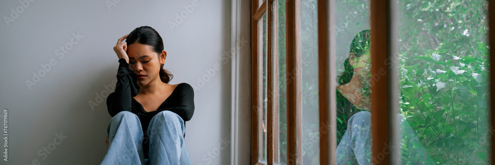 Depressed young Asian woman with mental health problem in mind need uttermost treatment from overthinking fatigue, disruptive thought, dissocial, anxiety and other mental health disorders . - obrazy, fototapety, plakaty 