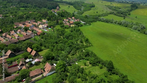 Viscri Village, famous travel destination in Romania. Beautiful and authentic country side of Romania with small village surrounded by agriculture files and forest. photo