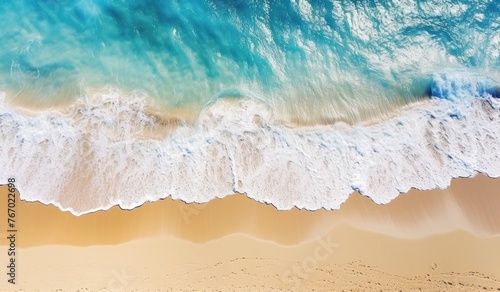 Aerial view of beach with crashing waves on a sunny day