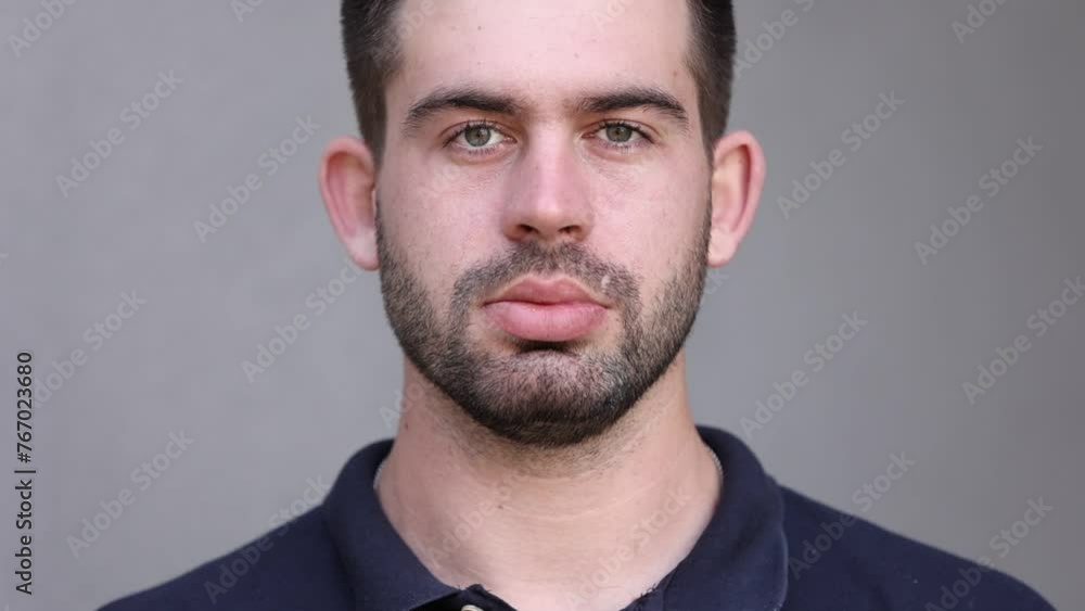 handsome brunette beard man in black t shirt blinking eyes and looking in camera. Guy with big lips and ears. expressive interesting face expression handsome brunette beard man in black t shirt blinking eyes and looking in camera. Guy with big lips and ears. expressive interesting face expression