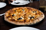 Hot pizza lunch or dinner crust mushroom topping, delicious tasty fast food on board table classic in side view .
