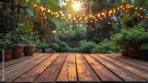   A wooden deck adorned with potted plants and a string of lights overhead