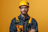 Professional electrician posing confidently with a warm smile against a yellow background