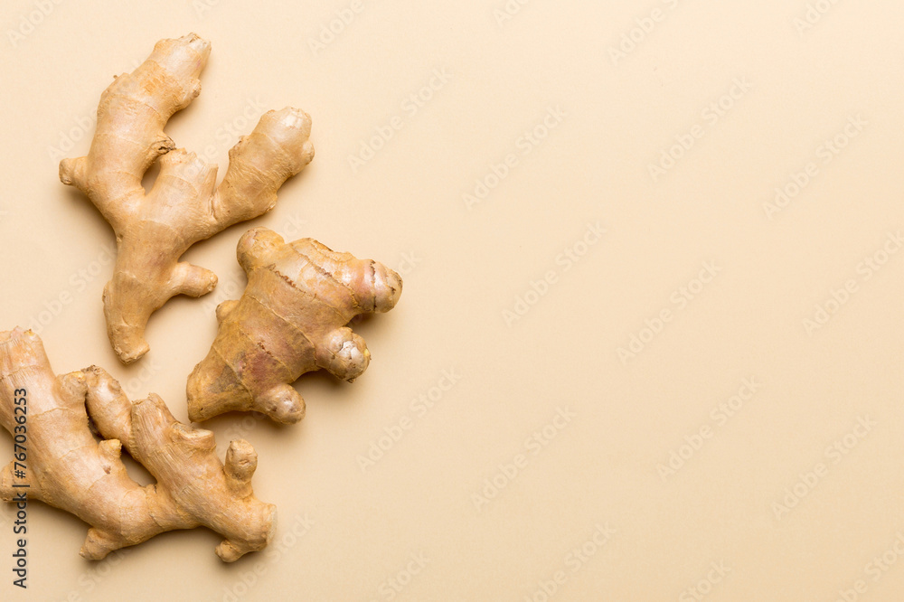 Finely dry Ginger powder in bowl with green leaves isolated on colored background. top view flat lay