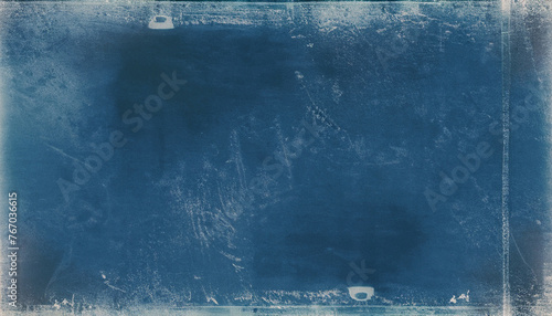 Distressed overlay. Dust scratches filter. Smeared dirt stains on dark blue weathered surface. Distressed chalkboard texture design. old-fashioned film edited by televisions