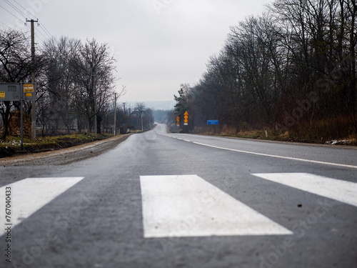 wet autumn road, with new white road markings