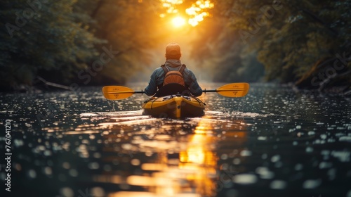  A person kayaking on a river under a sunlit tree canopy backdrop