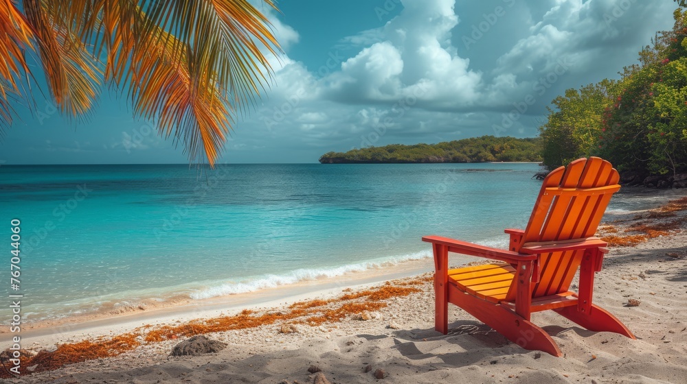   Red chair on beach beside blue water and palm tree in front