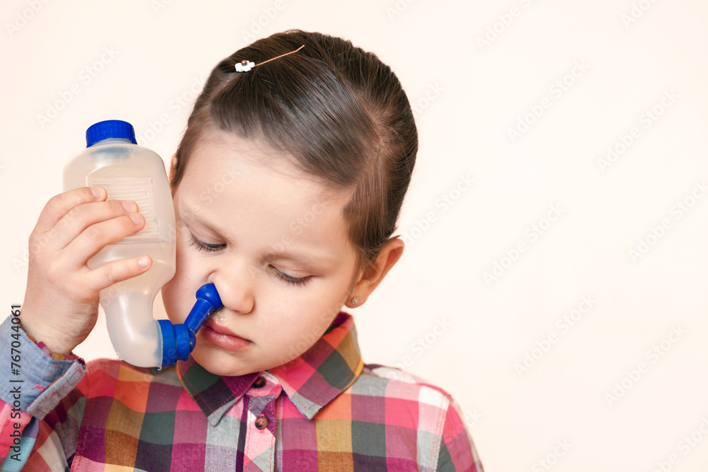 Nasal Irrigation for Nose or Sinus Rinse, Nasal Rinse for Children. Little Girl Child Washing her Nose with Saline Solution with Rinse Bottle. Nose Shower. Copy Space. Nasal Irrigation for Nose or Sinus Rinse, Nasal Rinse for Children. Little Girl Child Washing her Nose with Saline Solution with Rinse Bottle. Nose Shower. Copy Space.