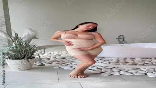 Beautiful pregnant woman in special pregnancy underwear. Advertisement of comfortable basic pregnancy underpants. Happy brunette girl show her panties in hall. Caucausian thin woman