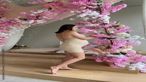 Beautiful pregnant woman in special pregnancy underwear. Advertisement of comfortable basic pregnancy underpants. Happy brunette girl show her panties in hall. Caucausian thin woman