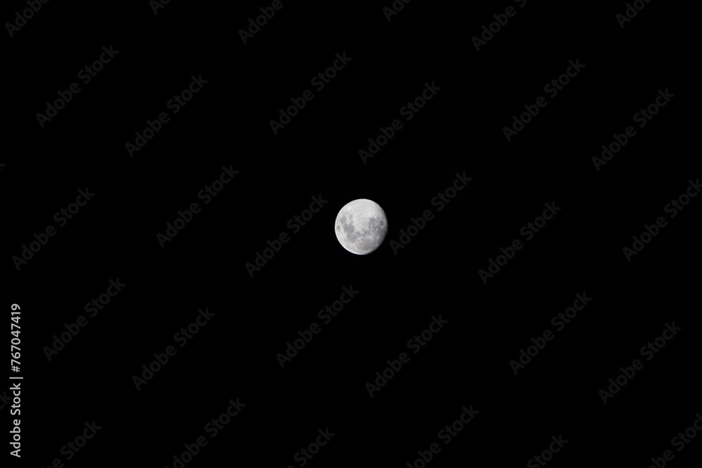Waxing gibbous Moon shining in the black night sky Waxing gibbous Moon shining in the black night sky
