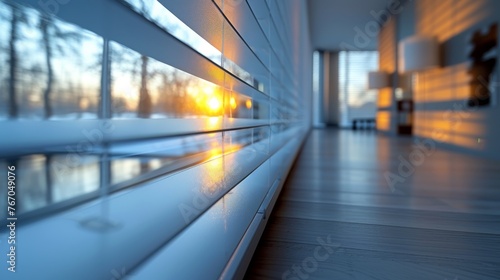   A picture of the exterior of a building viewed through a window with blinds positioned on the building's outer walls and the sun illuminating the windows © Viktor
