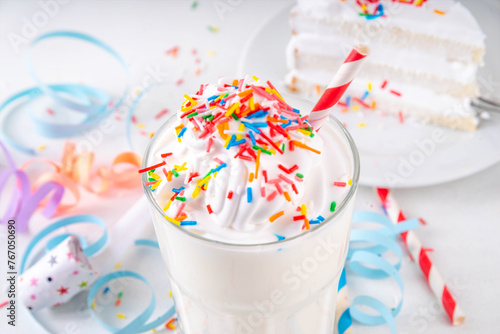 Birthday cake milkshake or smoothie drink. Frozen homemade Birthday cake white vanilla ice cream floating cocktail with whipped cream, and colorful sugar sprinkles, funfetti