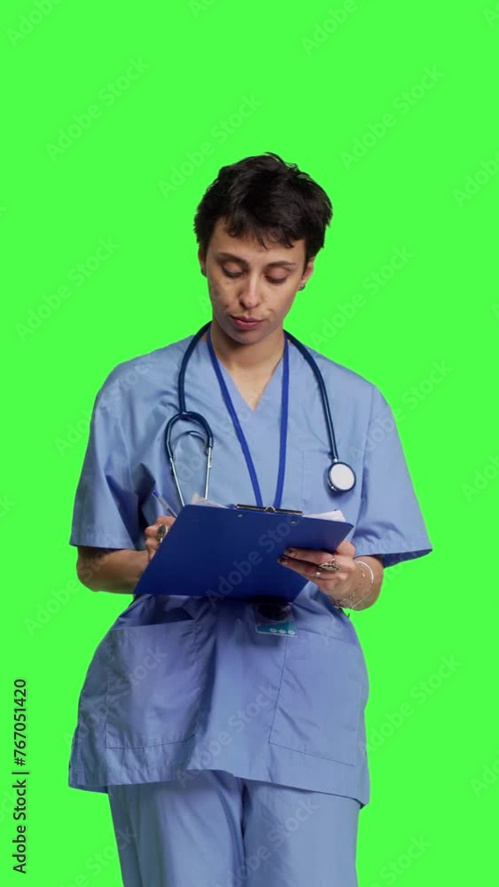 Front view Medical specialist examines x ray scan in hospital laboratory, looking at radiography to determine patient disease diagnosis. Nurse uses radiology expertise against greenscreen backdrop Front view Medical specialist examines x ray scan in hospital laboratory, looking at radiography to determine patient disease diagnosis. Nurse uses radiology expertise against greenscreen backdrop