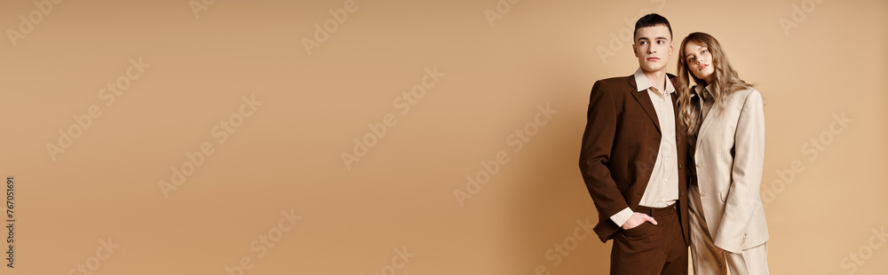 young man in elegant suit posing next to his appealing girlfriend who looking at camera, banner young man in elegant suit posing next to his appealing girlfriend who looking at camera, banner