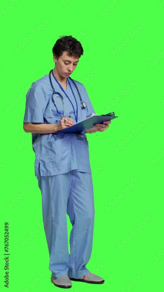 Side view Medical specialist examines x ray scan in hospital laboratory, looking at radiography to determine patient disease diagnosis. Nurse uses radiology expertise against greenscreen backdrop Side view Medical specialist examines x ray scan in hospital laboratory, looking at radiography to determine patient disease diagnosis. Nurse uses radiology expertise against greenscreen backdrop