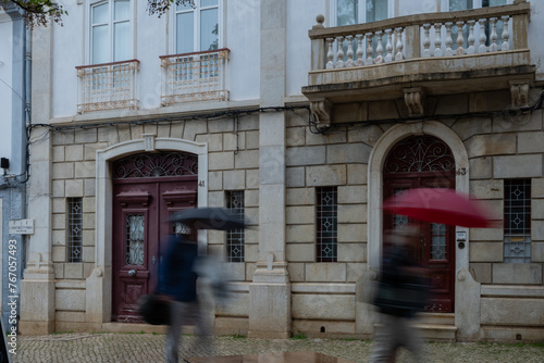 A rainy day in Lagos Portugal street people running to shelter. Deliberate motion blur used to create movement. tourist destination Algarve summer holiday place disappointing sunseekers in bad weather © drew