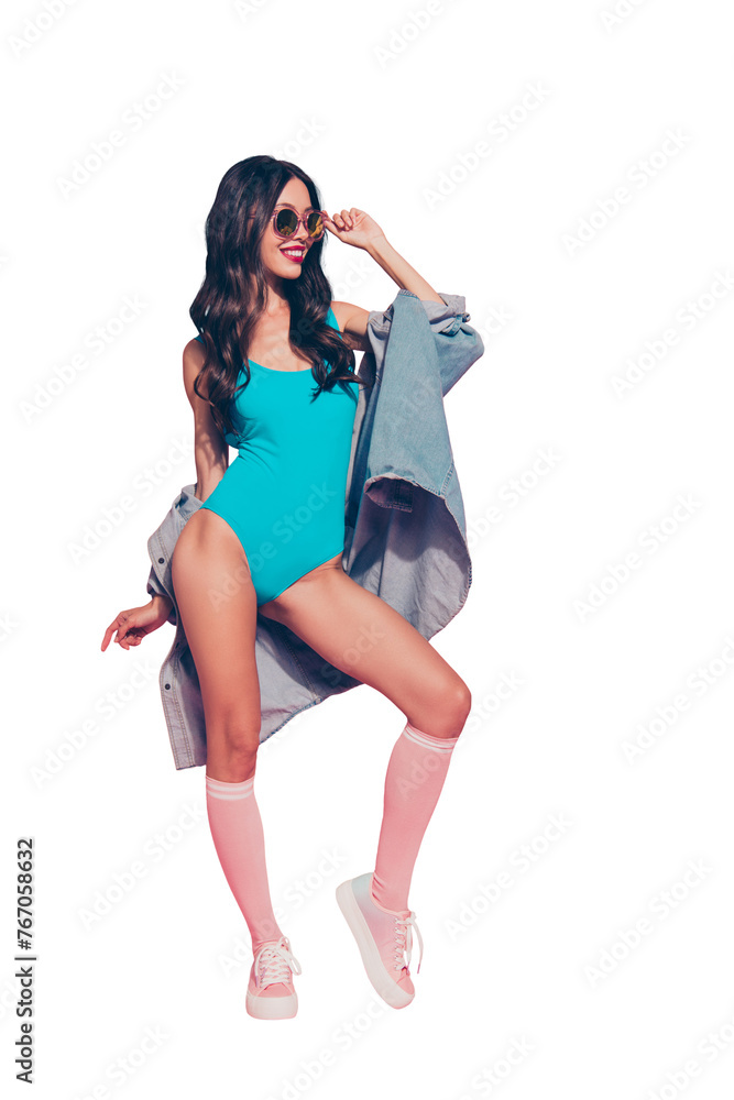 Vertical full length body size portrait of cool lovely magnificent wavy-haired lady red lips blue one-piece outfit shoes sneakers touching eyeglasses eyewear posing isolated over pink background Vertical full length body size portrait of cool lovely magnificent wavy-haired lady red lips blue one-piece outfit shoes sneakers touching eyeglasses eyewear posing isolated over pink background