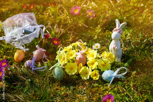 Easter bunny with Easter eggs on the grass at Easter.