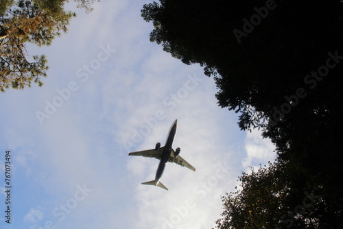 an airplane in the air above a tree
