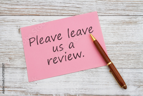  Please leave us a review pink greeting card with pen on wood