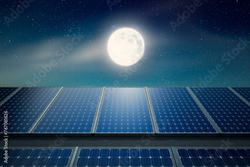 Fototapeta Naklejka Na Ścianę i Meble -  Captivating View of Solar Panels Basking Under a Moonlit Starry Night Sky